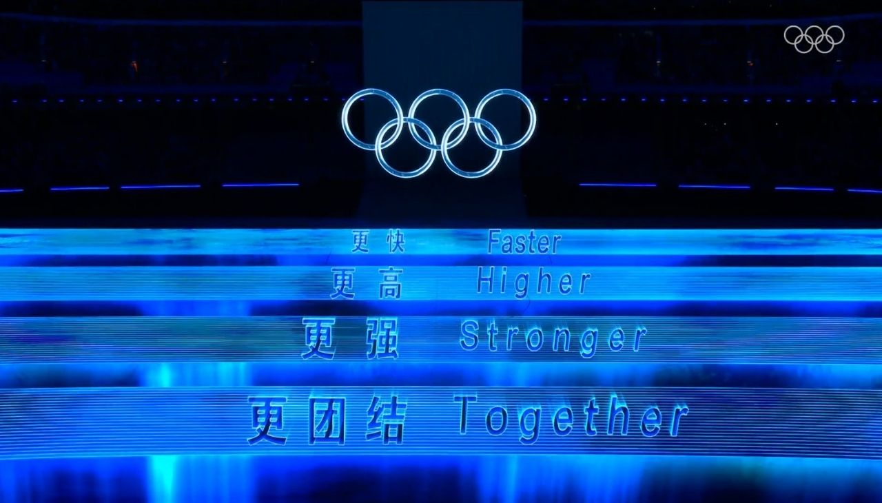 The Olympic motto of 'Faster, Higher, Stronger - Together' lights the way at the Opening Ceremony. Photo: Twitter