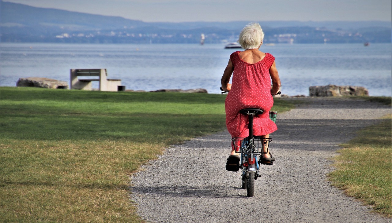 Elder woman riding a bike.