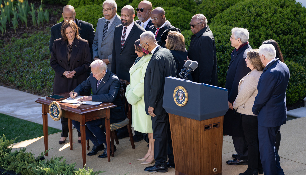 President Joe Biden signing new legislation. 