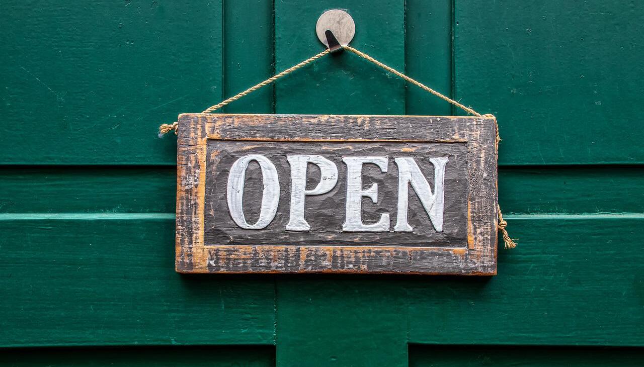 Wooden door with open sign on. 