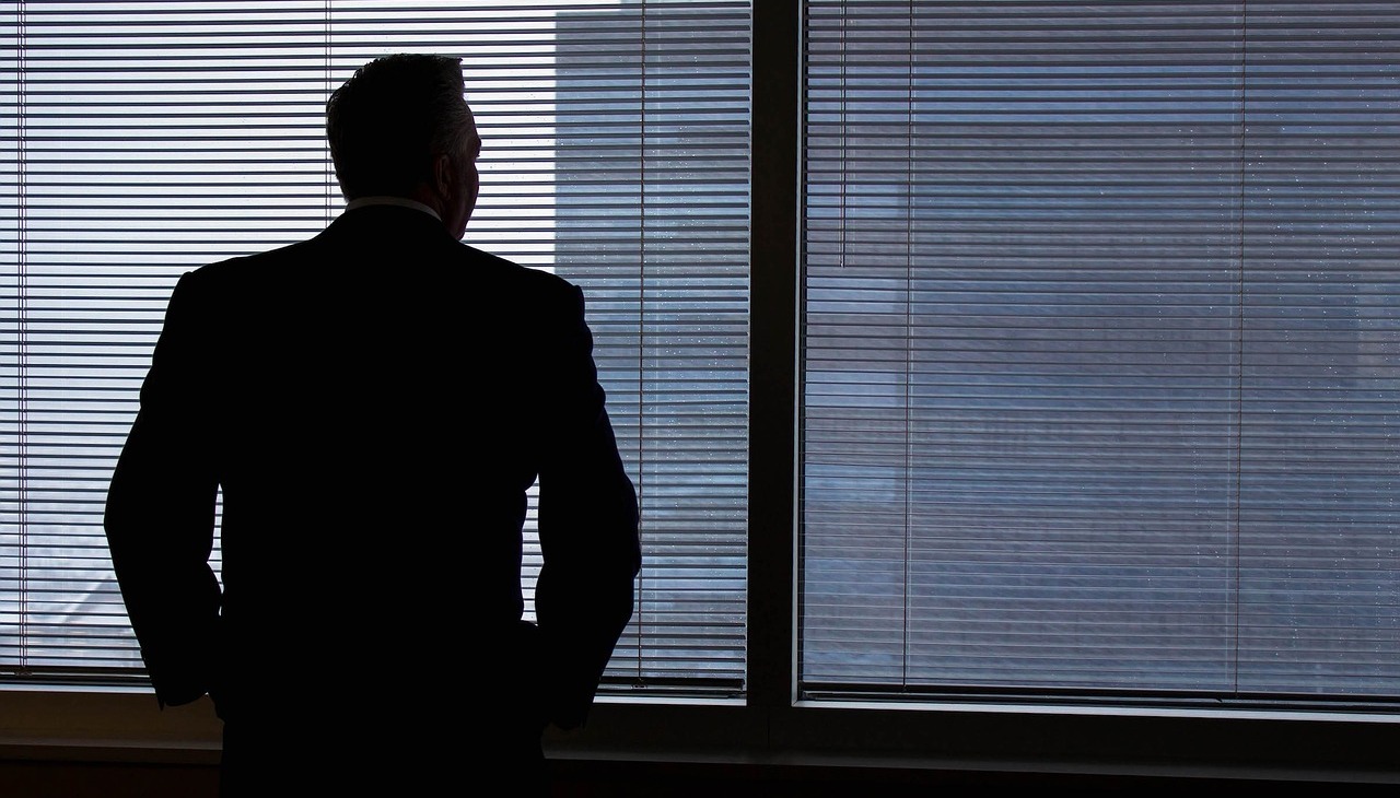 Businessman looking trough the window.