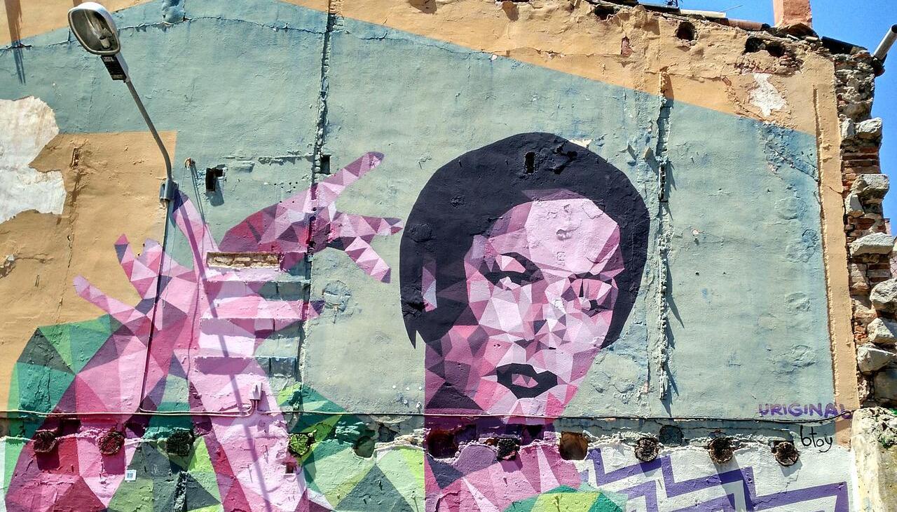 Migrant woman painted on a street wall. 