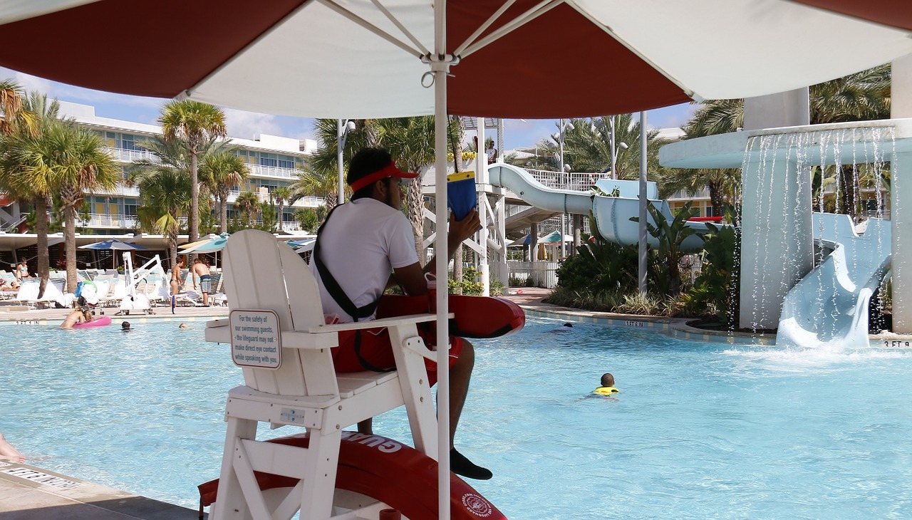 Young guy has a summer job by the pool.