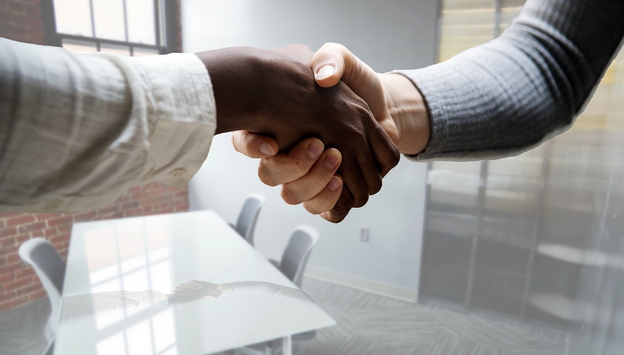 Two people handshaking at a job interview. 