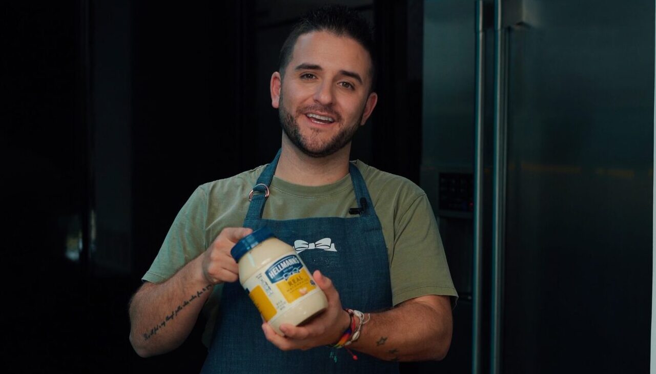 Colombian Chef Juan Manuel Barrientos holding a jar of Hellmann's mayonnaise.