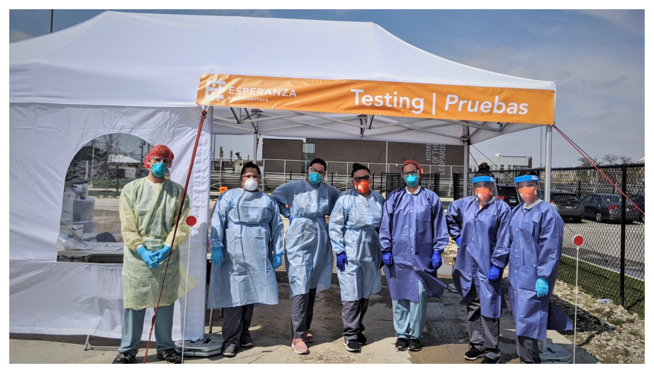 A vaccination tent run by Esperanza. The staff are standing outside the tent for the photo.