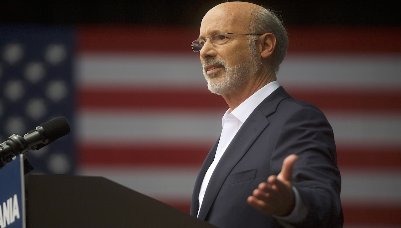 Pictured: Pennsylvania Governor Tom Wolf against U.S. flag.