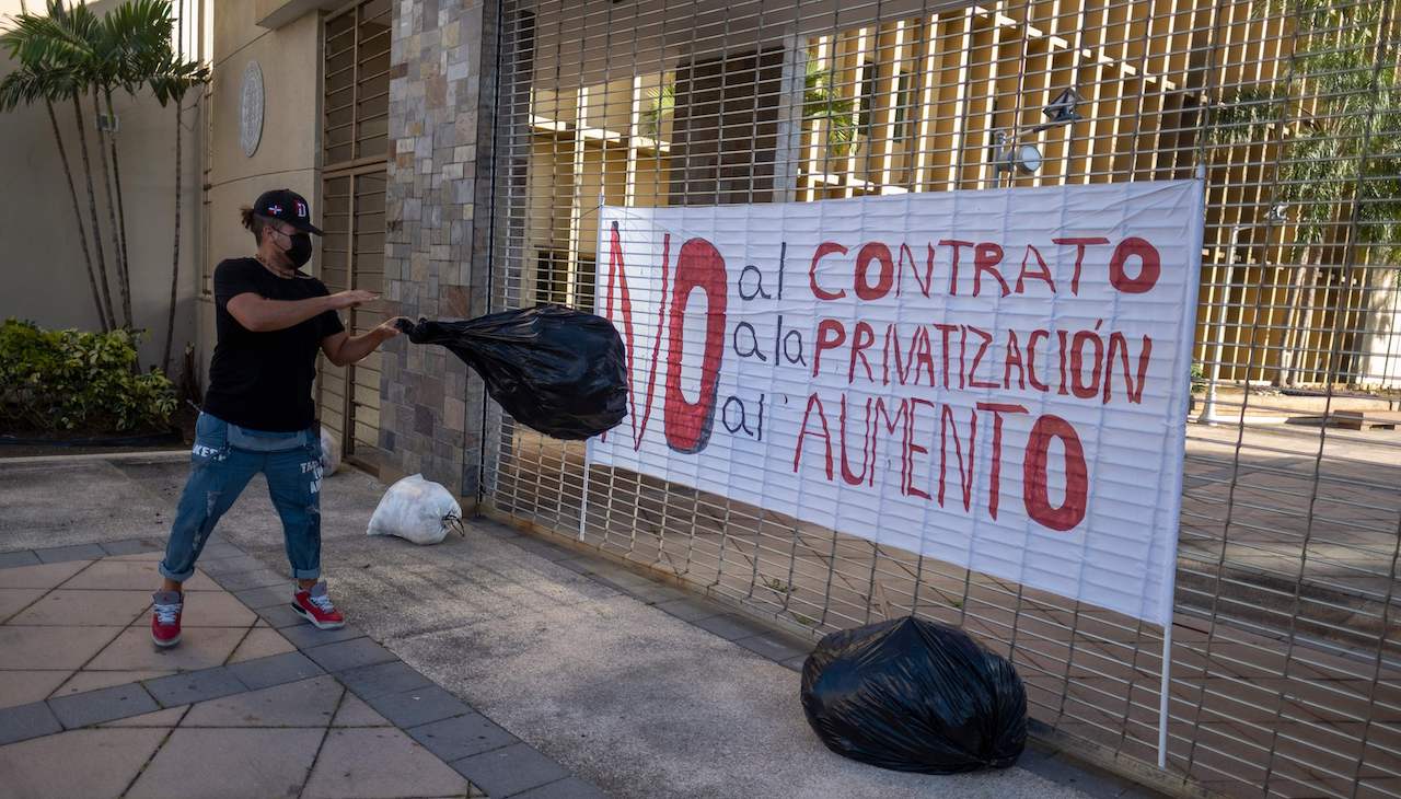 Pictured: LUMA headquarters in San Juan, Puerto Rico with picket signs hung on the entrance.