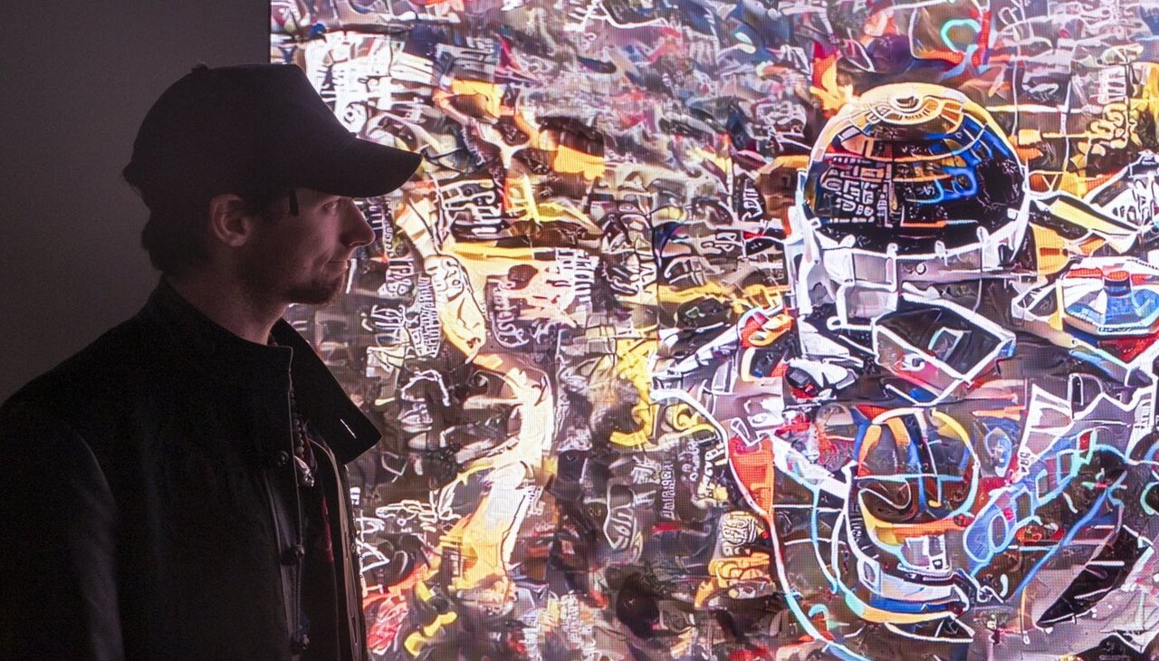 Nate Mohler in front of one of his digital art pieces.