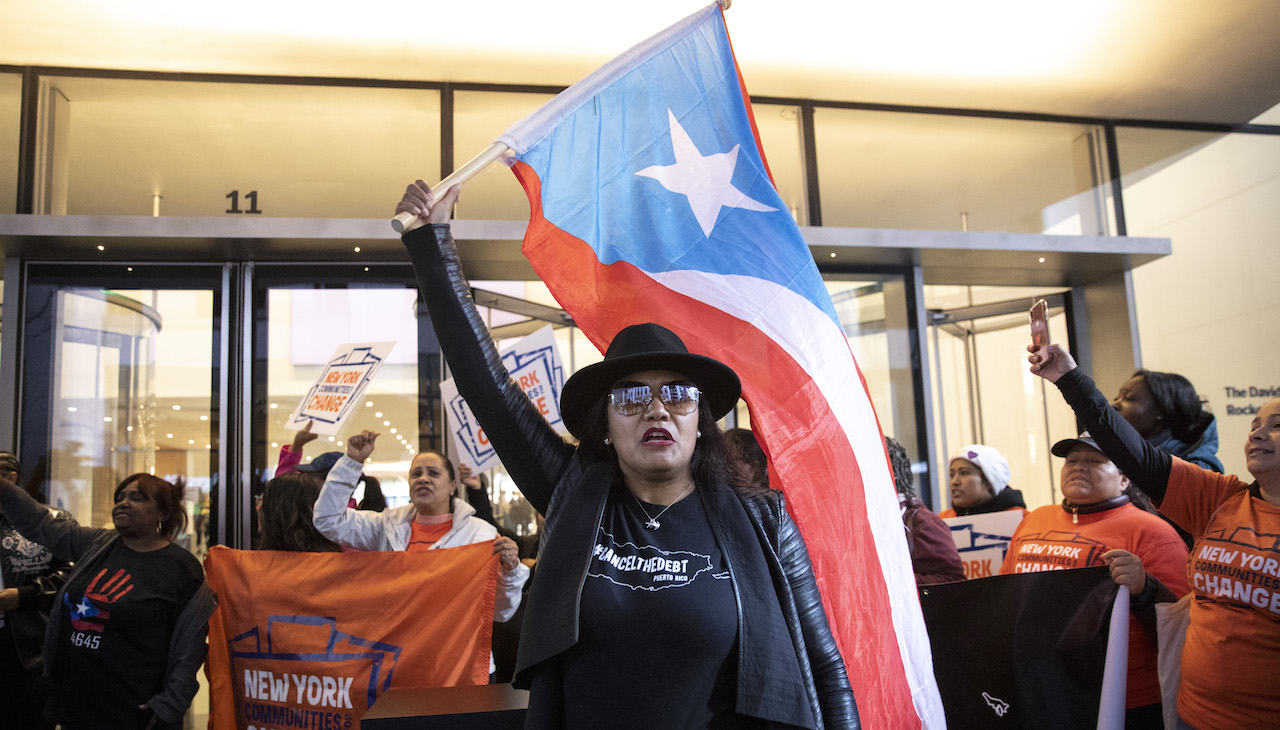 Pictured: Puerto Rican activists protest in front of NY Museum of Art