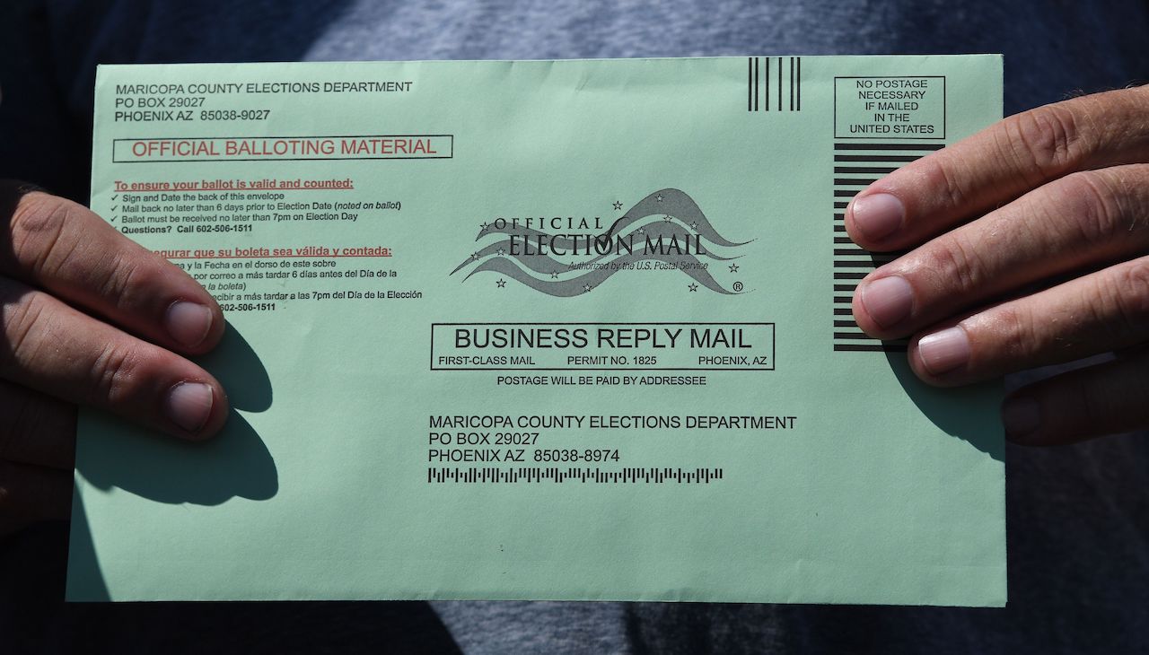 Arizona resident holding their mail-in ballot