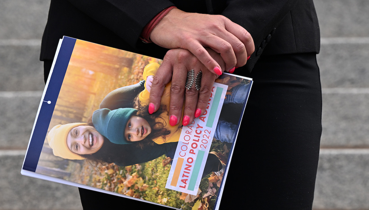 Pictured: Beatriz Soto, Director of Protégete for Conservation Colorado holds a copy of The Colorado Latino Policy Agenda (CLPA)