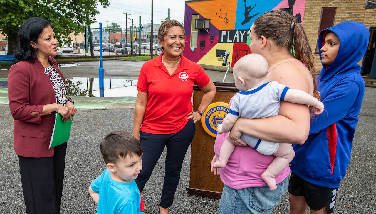 Pictured: María Quiñones-Sánchez speaks with parents at school playground