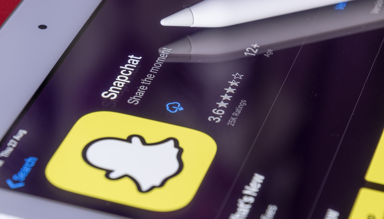 Phone screen displaying Snapchat logo.