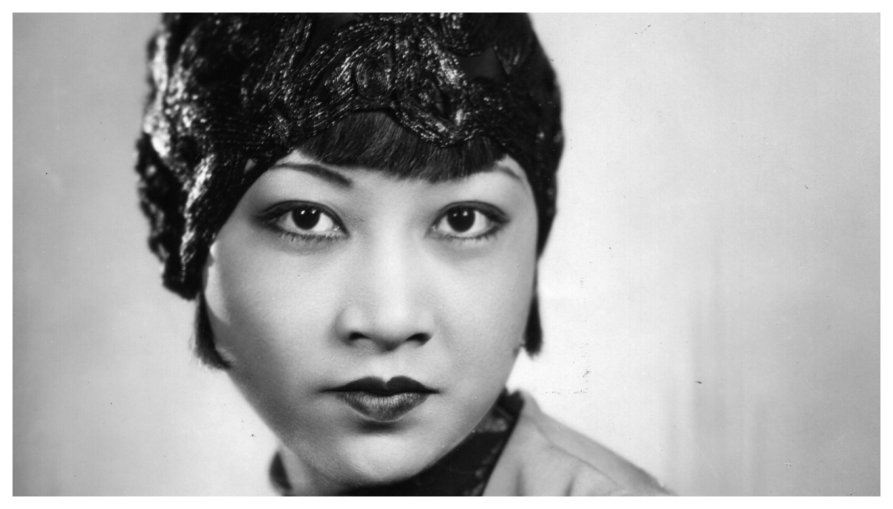 A black and white photo of Anna May Wong, an Asian American woman.