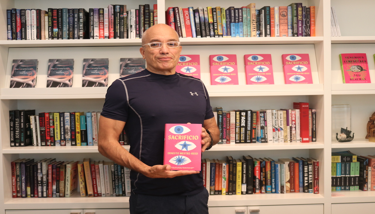 Ernesto Mestre-Reed holding the book. 