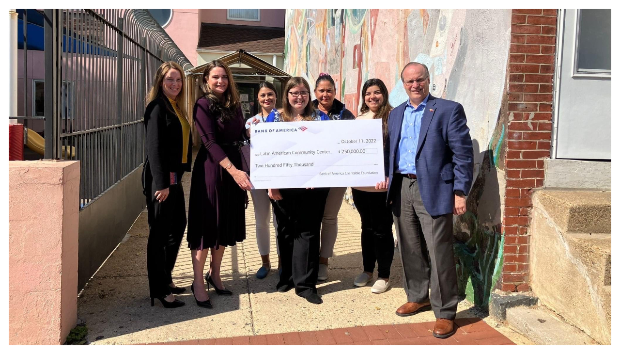 A group of people holding a large check for $250,000.