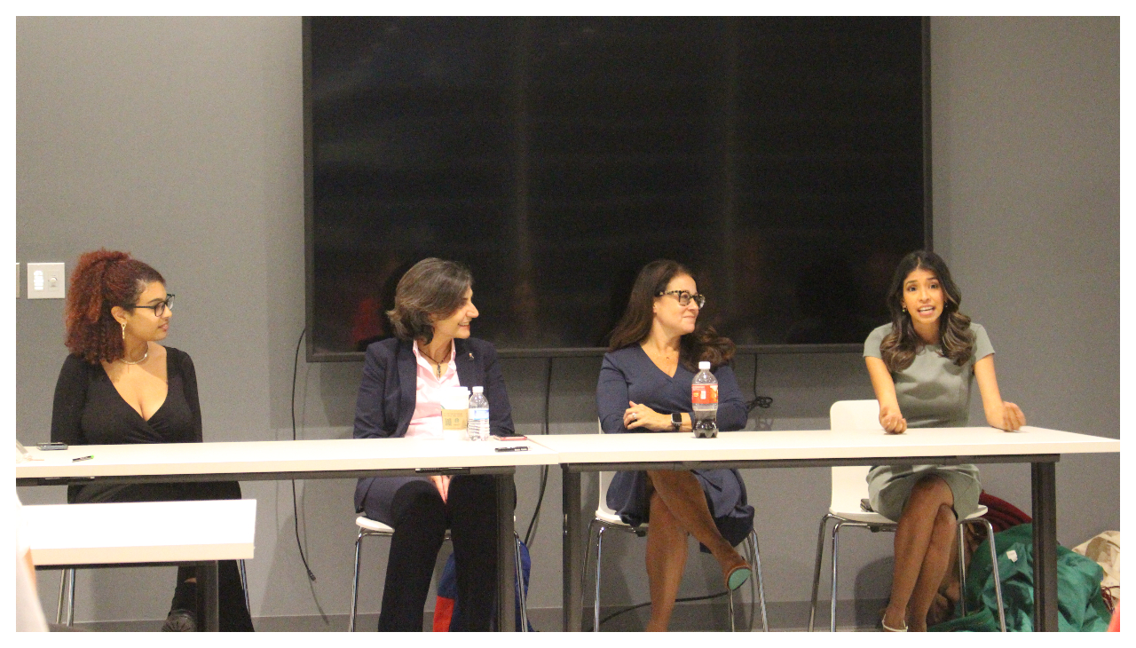 Four latina women sitting at a table.