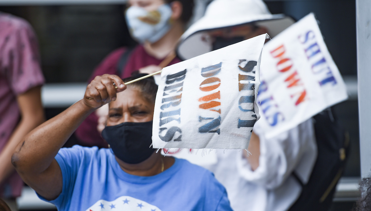 Shut Down Berks coalition activists holds a sign that reads "Shut Down Berks." Photo: Ben Hasty/MediaNews Group/Reading Eagle via Getty Images,