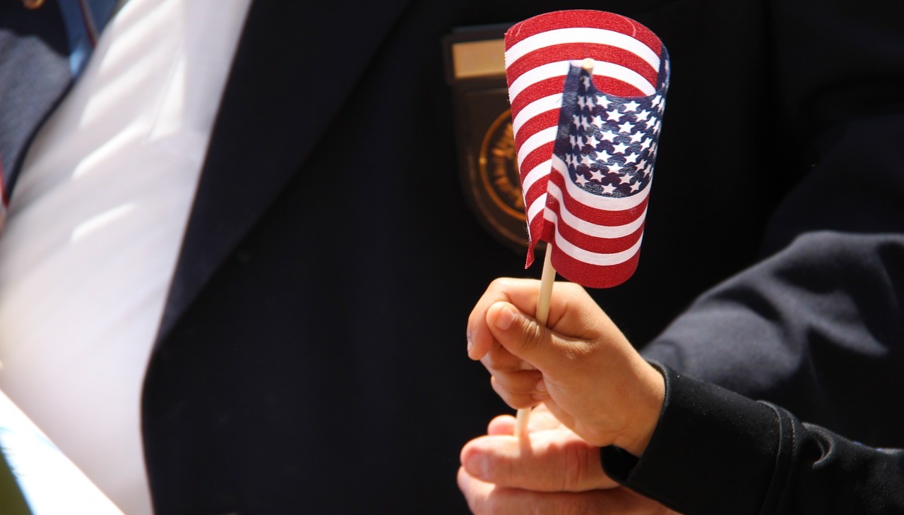 A child holds a small U.S. flag to honor veterans. 