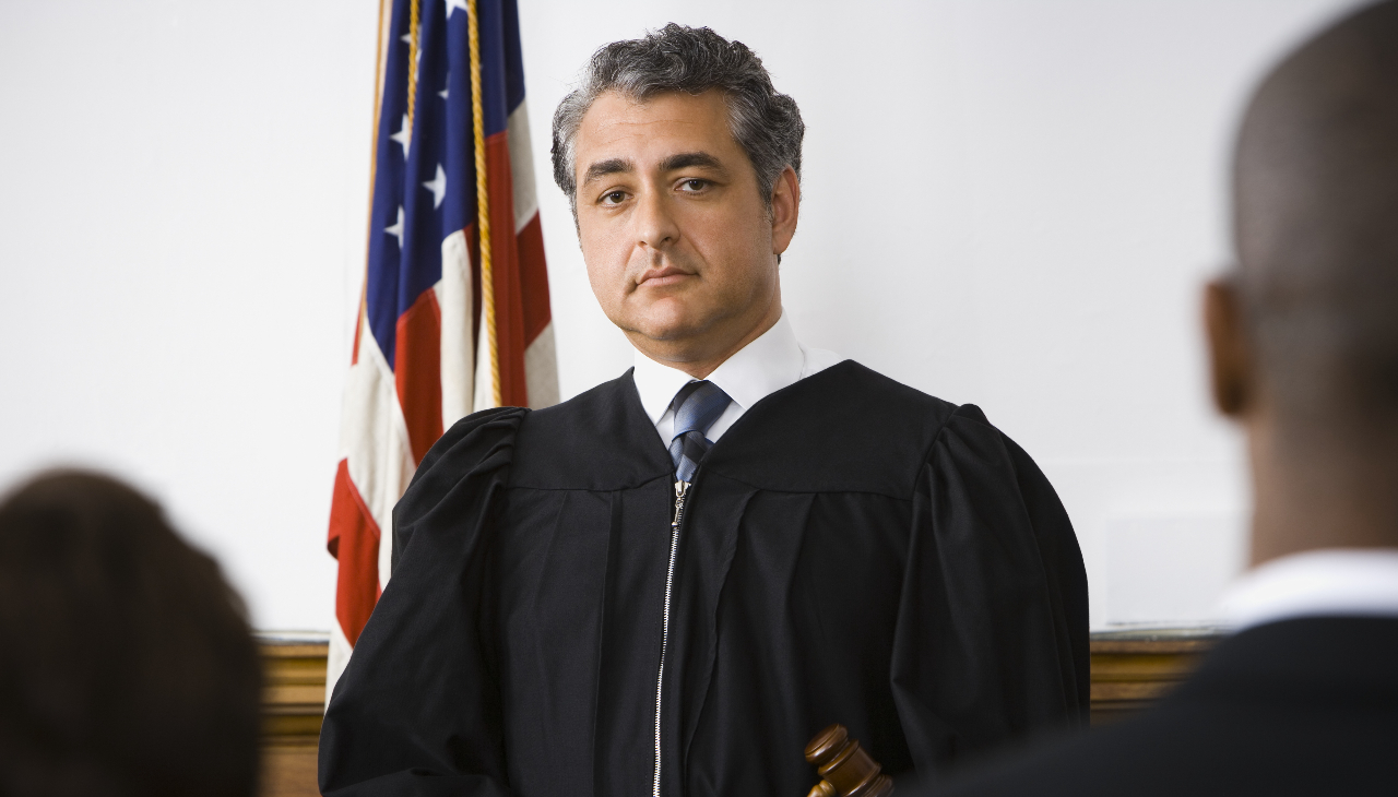 Judge standing in front of people. Photo credit: Stock photo