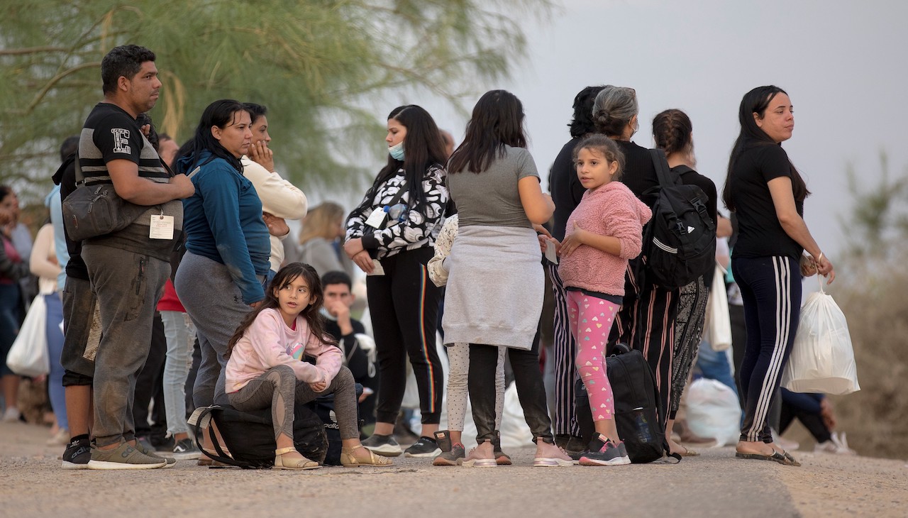 Migrants await a bus going north in Eagle Pass, Texas. 