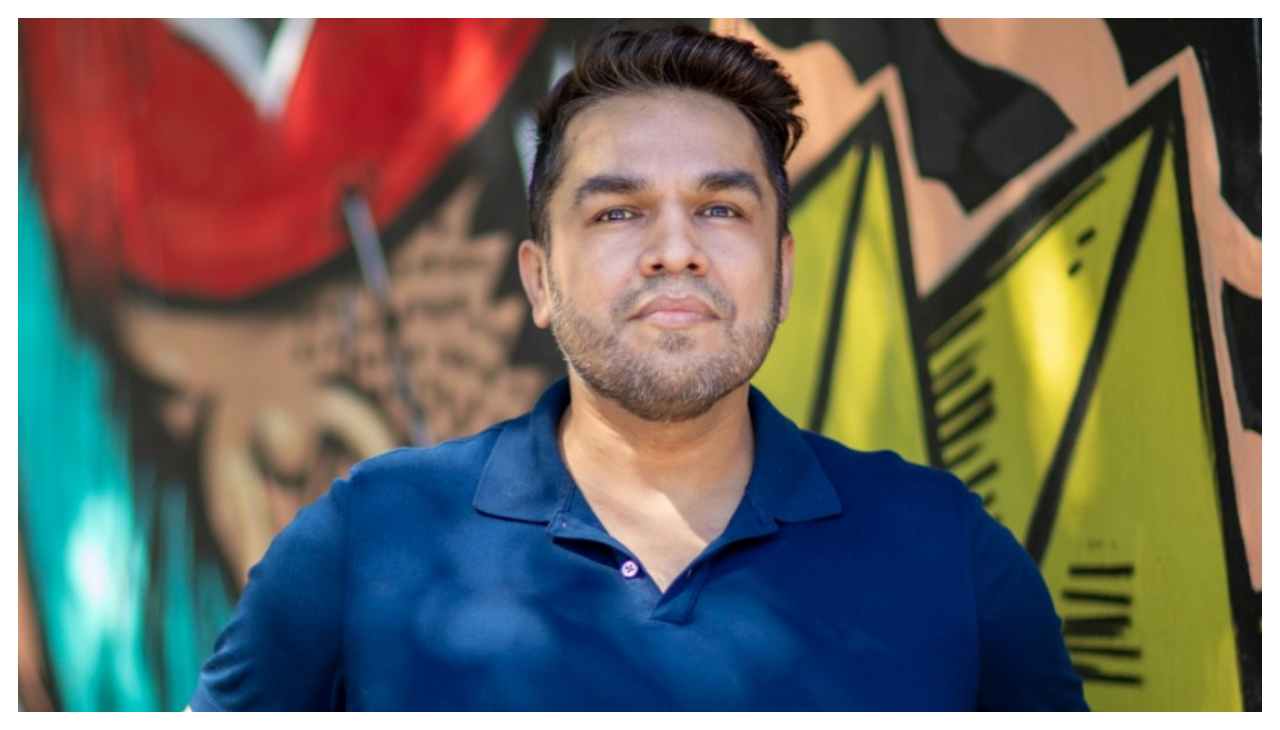 Jorge Valdivia, a latino man wearing a blue shirt. He is looking at the viewer.