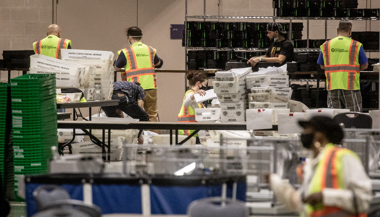 People count votes in the Philadelphia Convention Center in 2020.