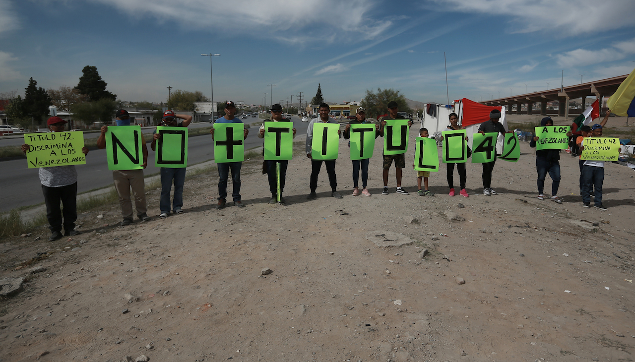 Protesters hold signs with letters in order that read "Down with Title 42" Photo: Christian Torres/Anadolu Agency via Getty Images