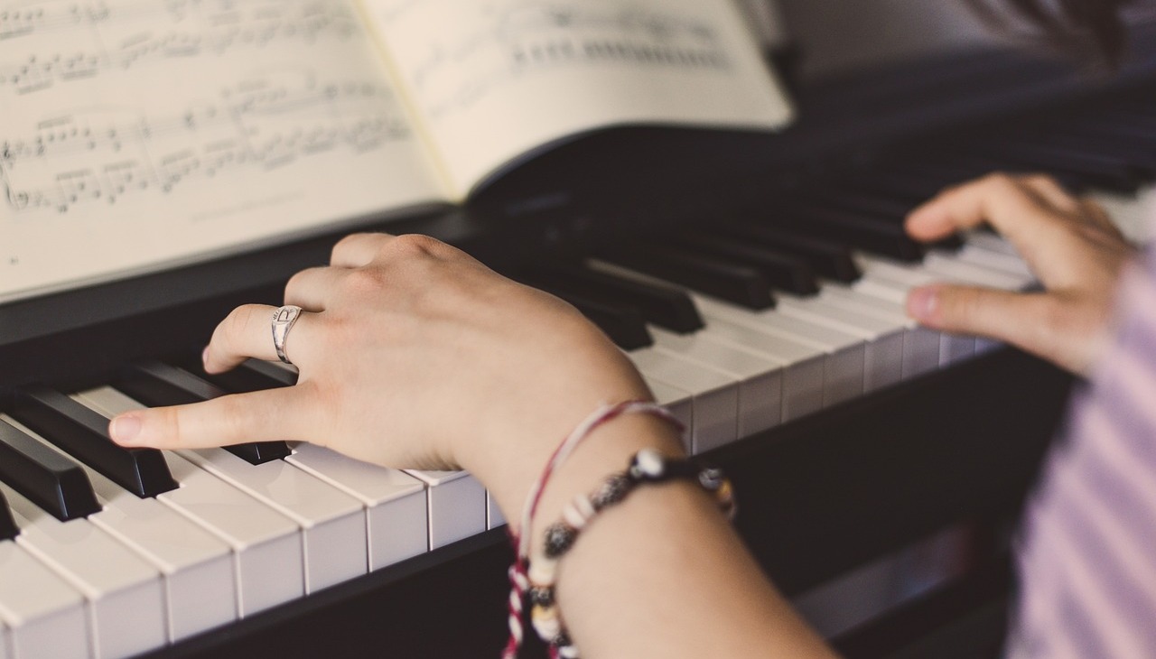 Girl playing a piano.