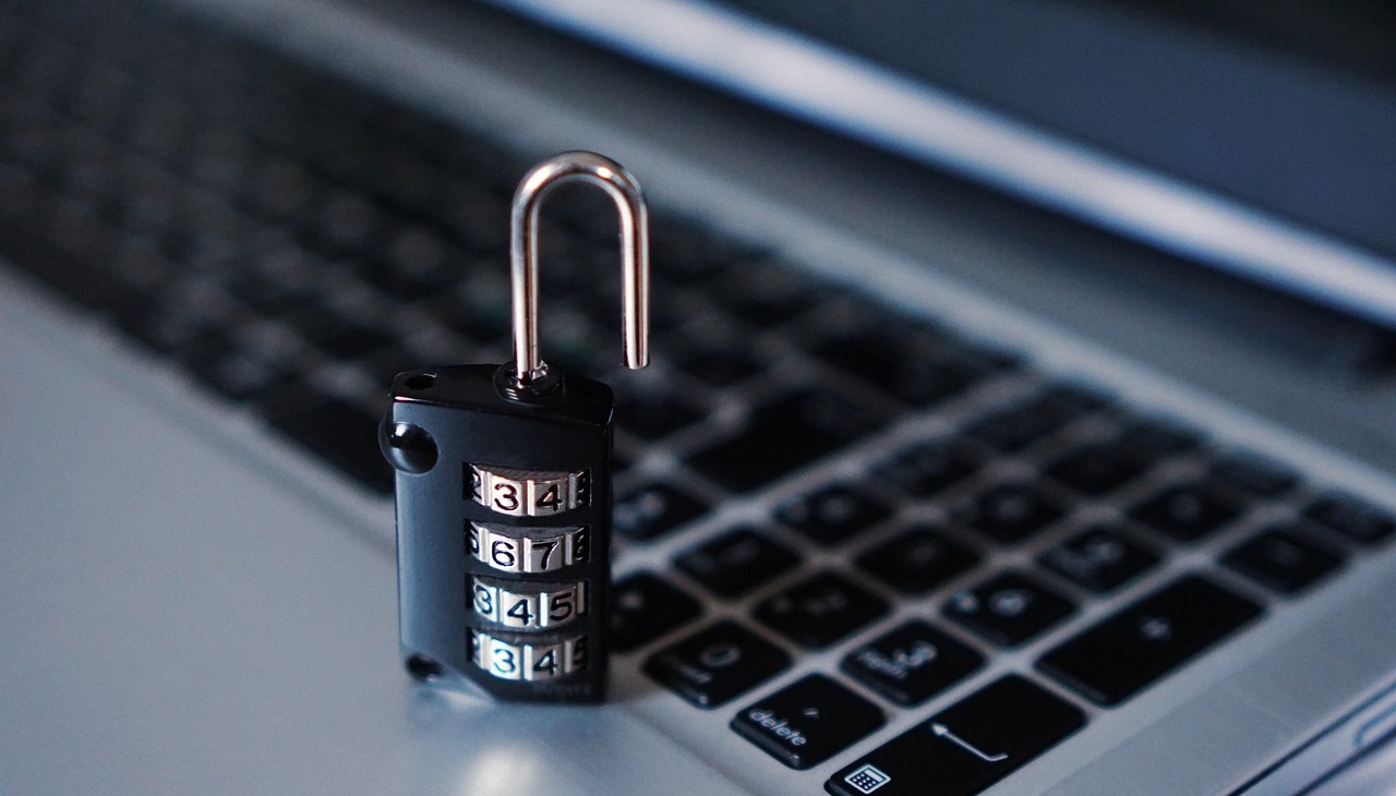 A lock placed on top of a laptop. 