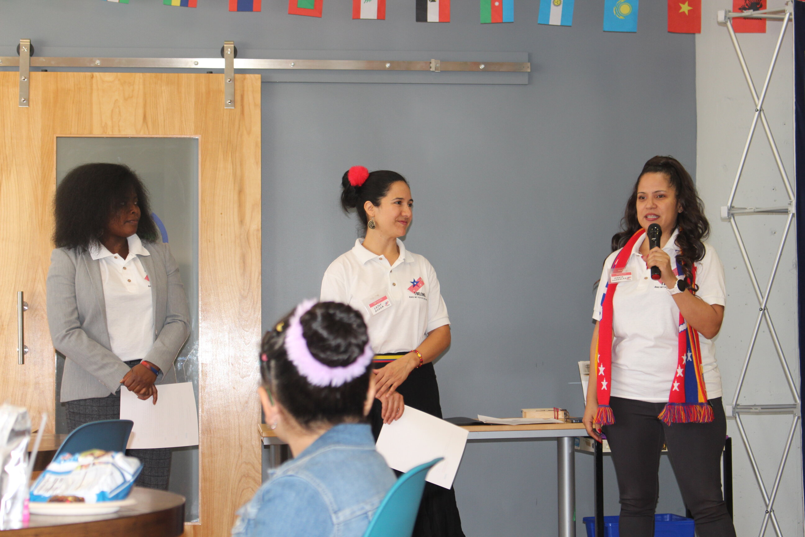 Three members of the I Belong Philly team welcome attendees to the 4th "One City, Many Cultures" event. Photo: Jensen Toussaint/AL DÍA News.