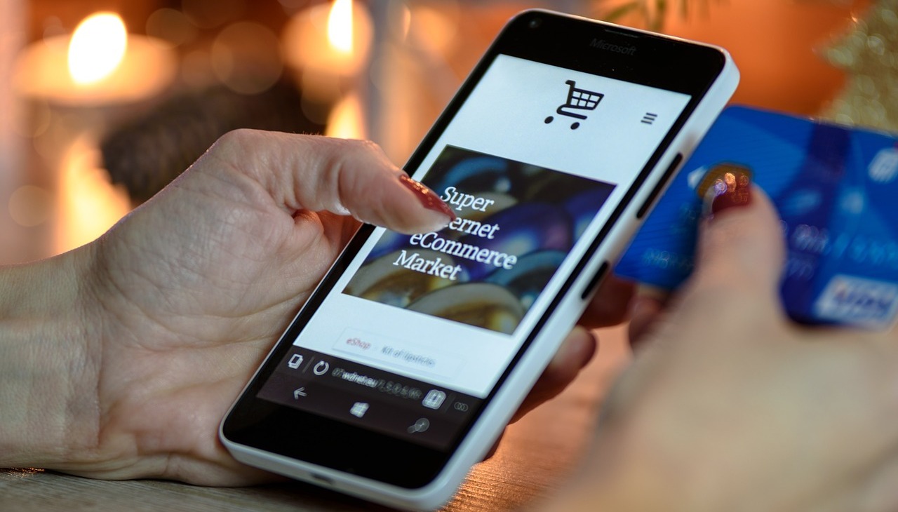 Woman shopping on line through her cell phone. 