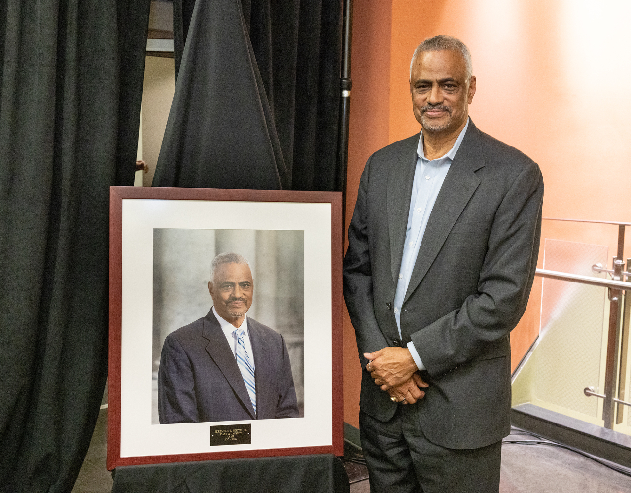 Immediate past board chair, Jeremiah White, standing next to his newly unveiled portrait. Photo courtesy of Community College of Philadelphia