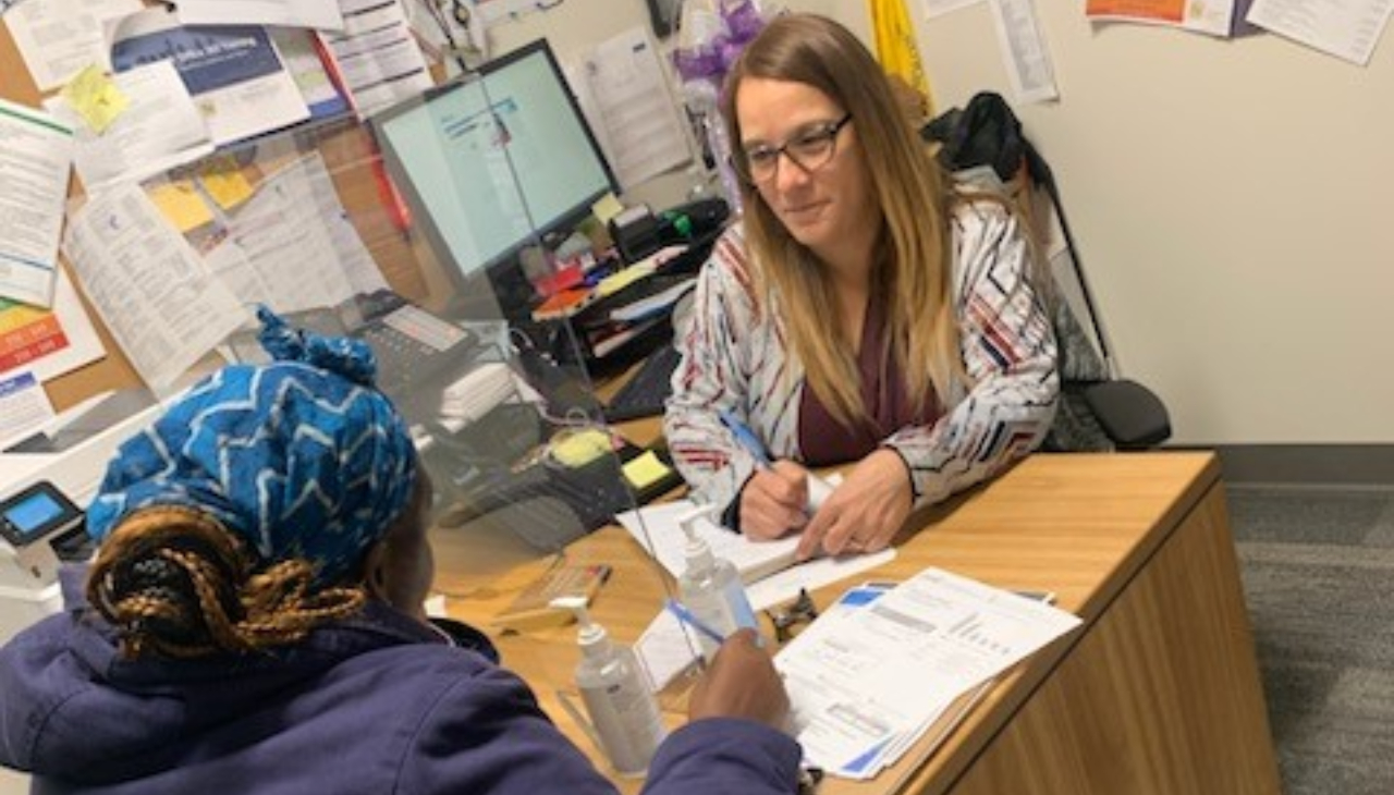 Ivette Velez, Energy Advisor, Housing Advisor, at the New Kensington CDC, provides a customer assistance with her PGW account. Photo Courtesy of New Kensington CDC. 