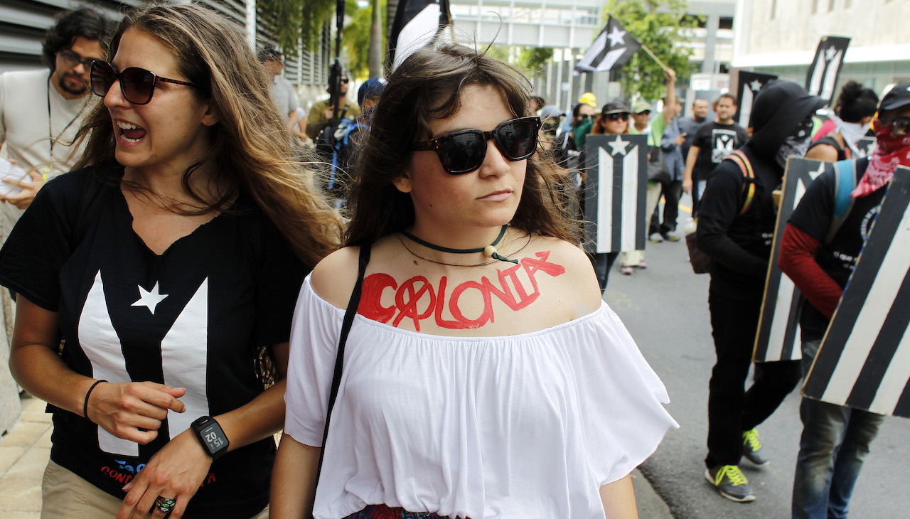 Puerto Rican activists march. Photo: Ricardo Arduengo/AFP via Getty Images.