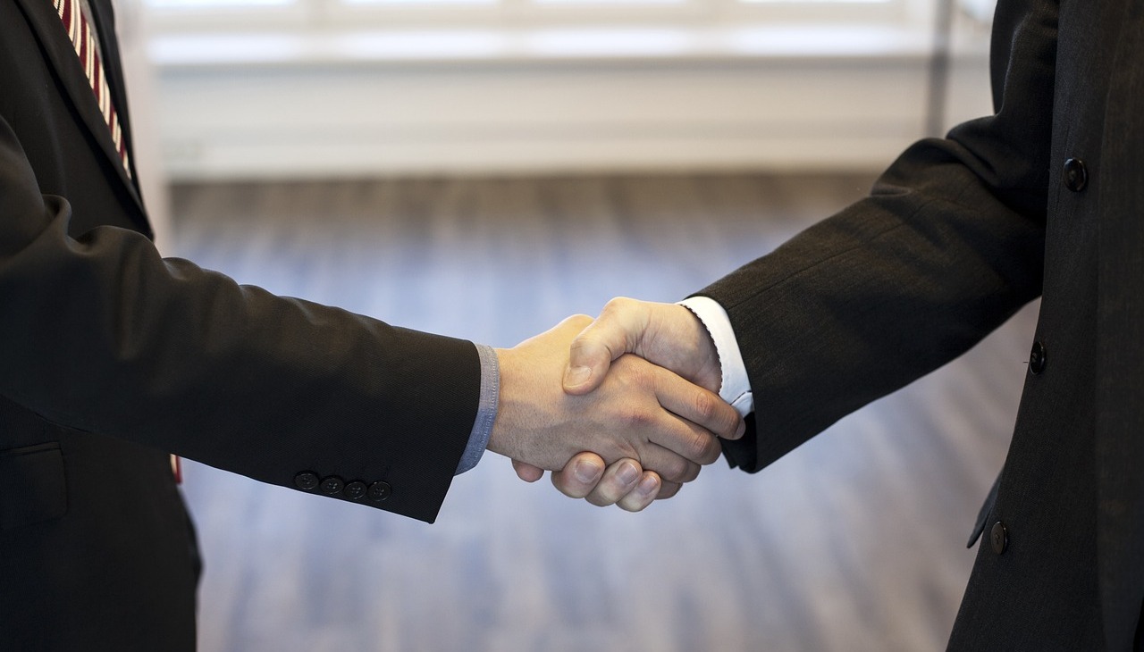 Two man shaking hands in sign of trust.