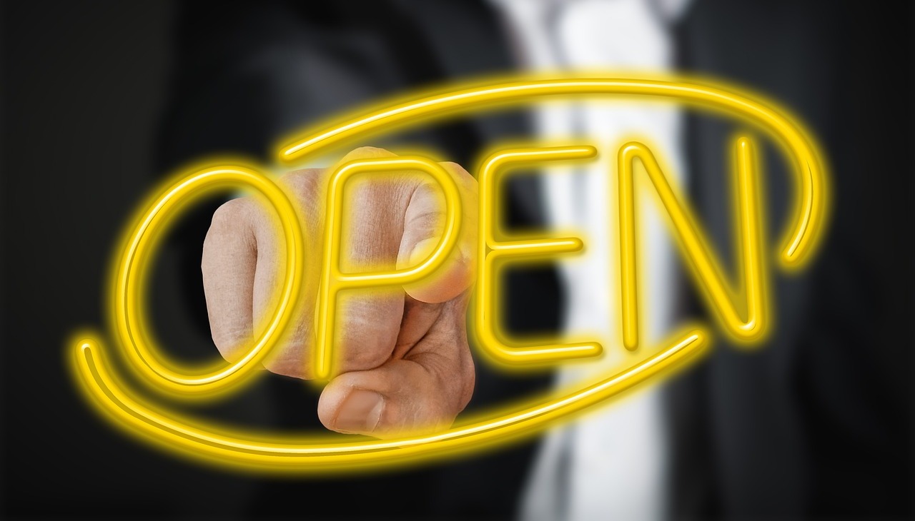 Man pointing with his finger open neon sign.