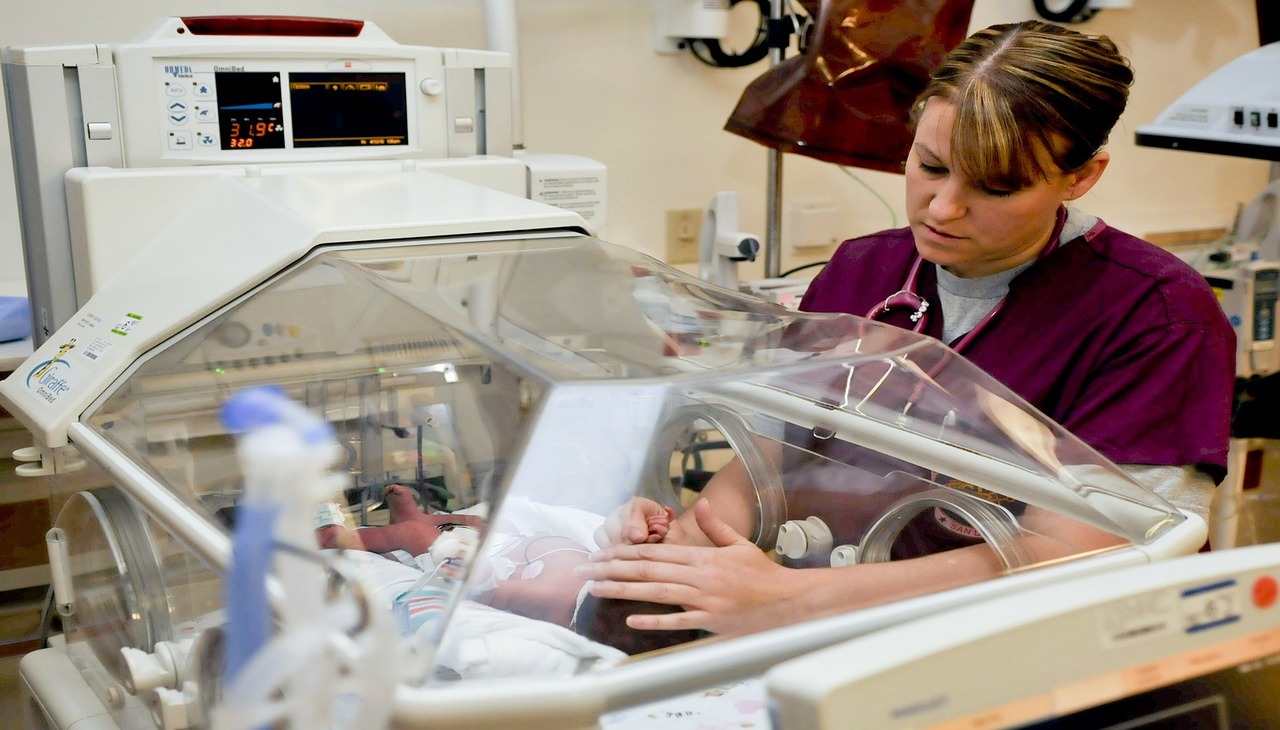 Nurse takes care of a new born child. 