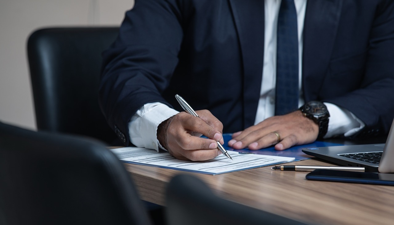 Man signing law documents.