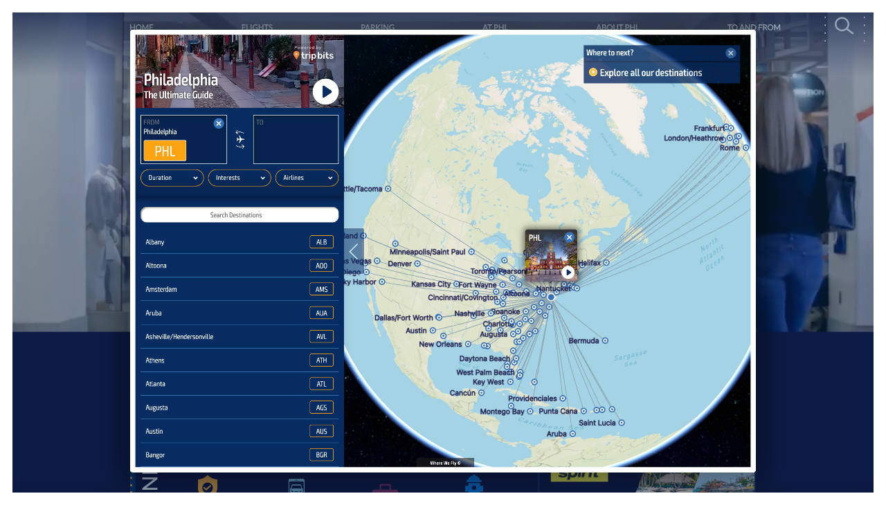 A screenshot of the WhereWeFly service on the PHL website, showing a globe, an icon for the PHL, and a web of other possible destinations from the airport.