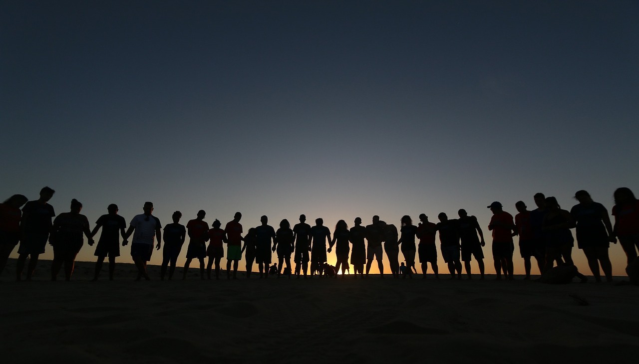 Group of young people posing on a hill. 