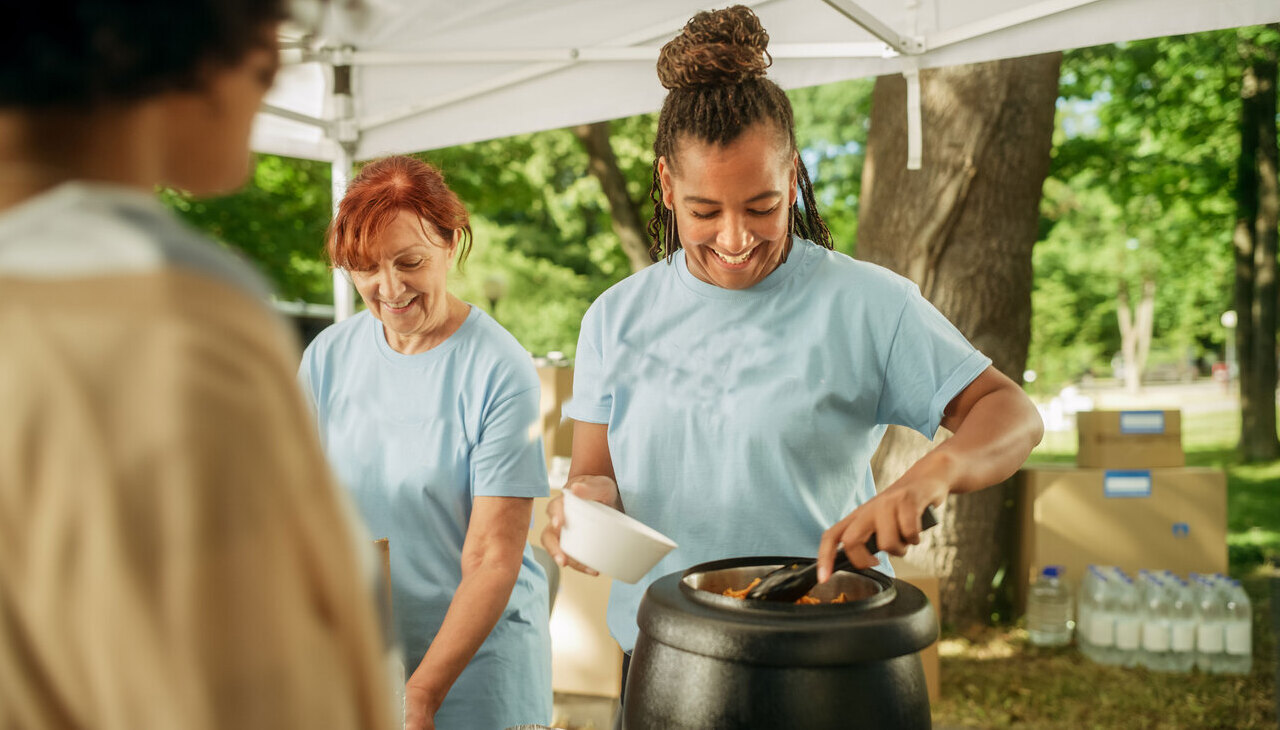 Social worker serving meals.