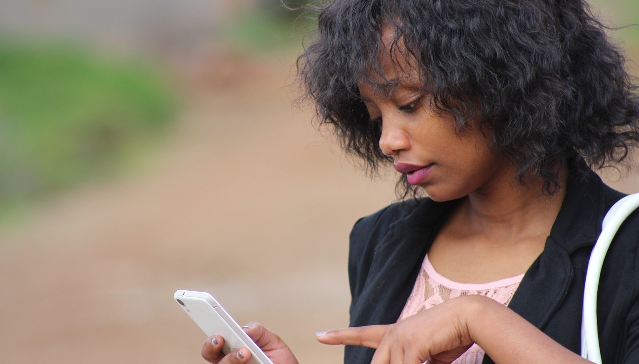 African-American woman checking her phone. 