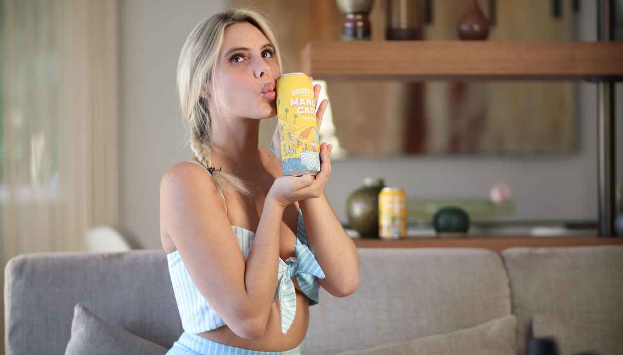 Lele Pons with a Golden Rodad Brewing beer.