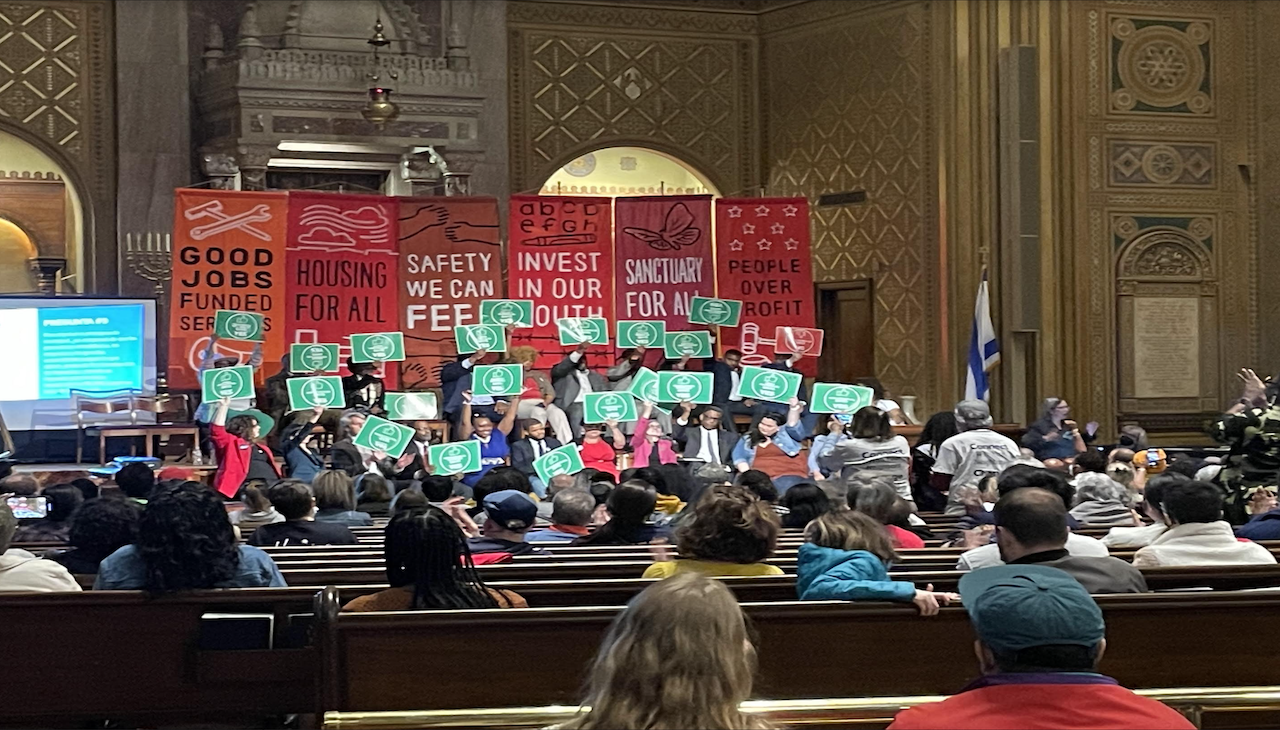 Candidates for Philadelphia City Council held up affirmative banners in forum. Photo: Alliance for a Just Philadelphia