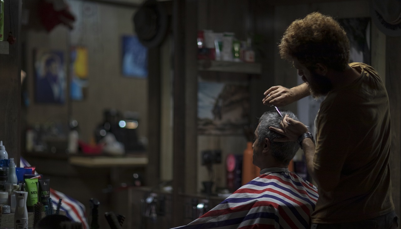 Barber giving customer a hair cut.