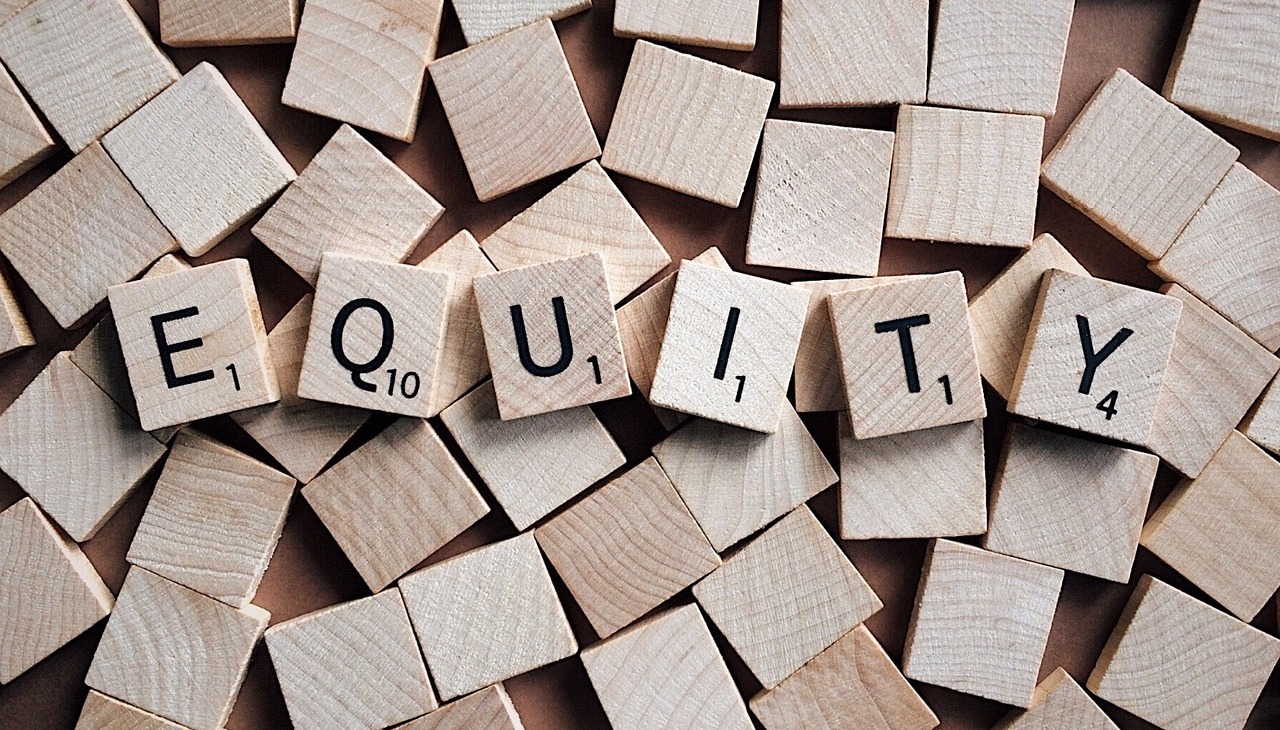 Equity spelled with wooden blocks.