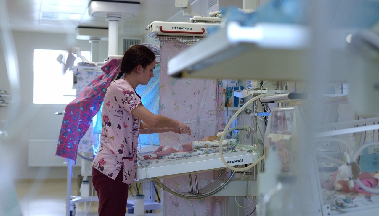 Nurse taking care of a new born baby.