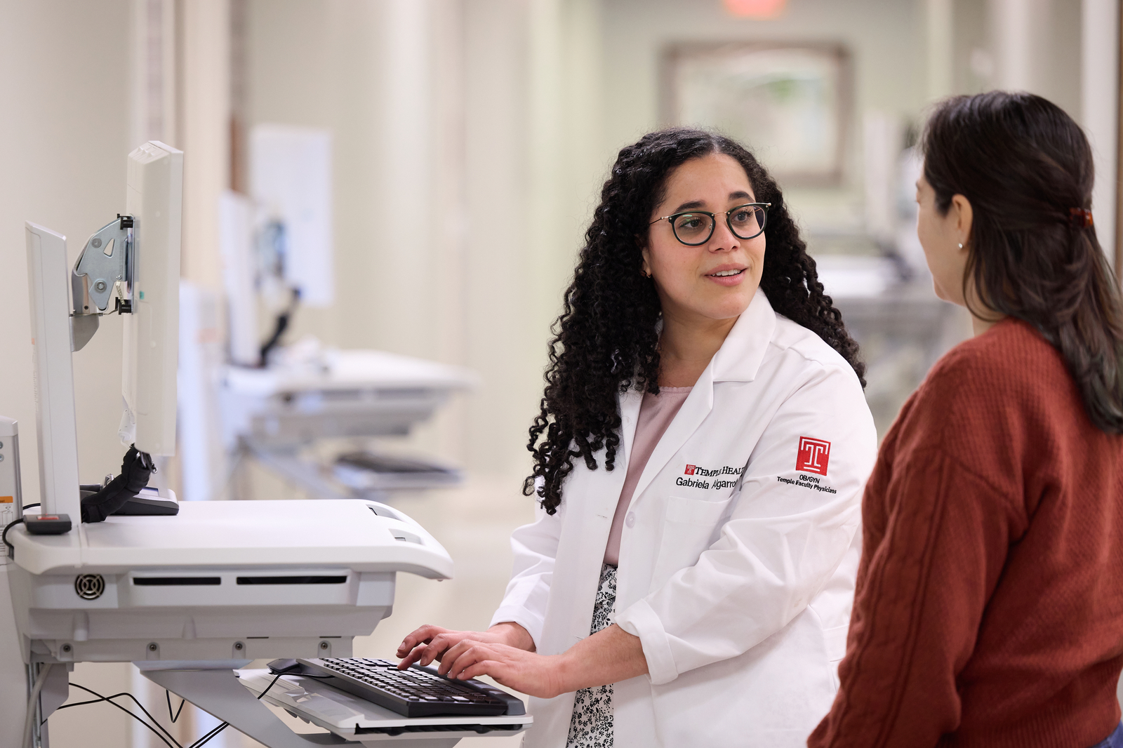 Dr. Gabriela Algarroba speaking to a patient. Dr. Algarroba is one of seven physicians who will be on staff at the outpatient OB/GYN practice at Temple Health's Women & Families campus. Photo courtesy of Temple Health